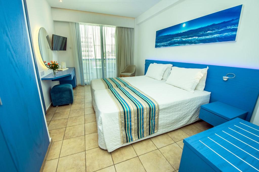 a hotel room with a bed and a television at Anonymous Beach Hotel (Adults 16+) in Ayia Napa
