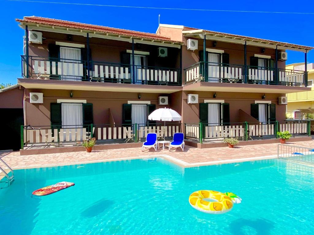 a villa with a swimming pool in front of a house at Villa Plastiras Sidari with private pool in Sidari