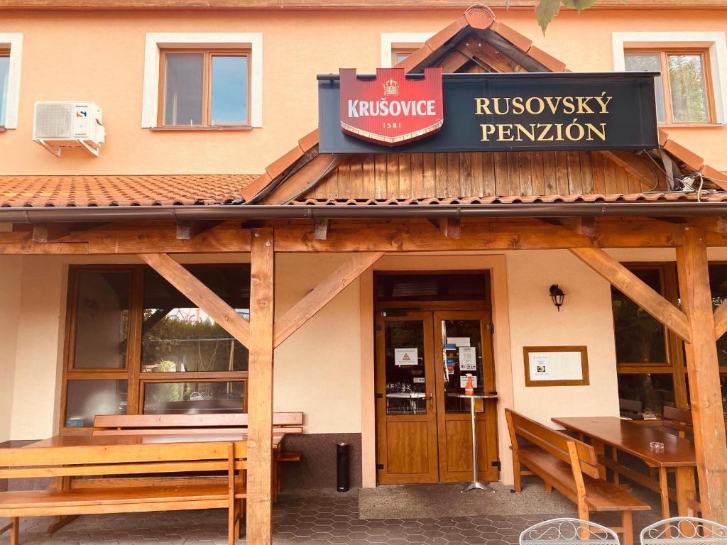 
a restaurant with a sign on the front of it at Rusovský Penzión in Bratislava
