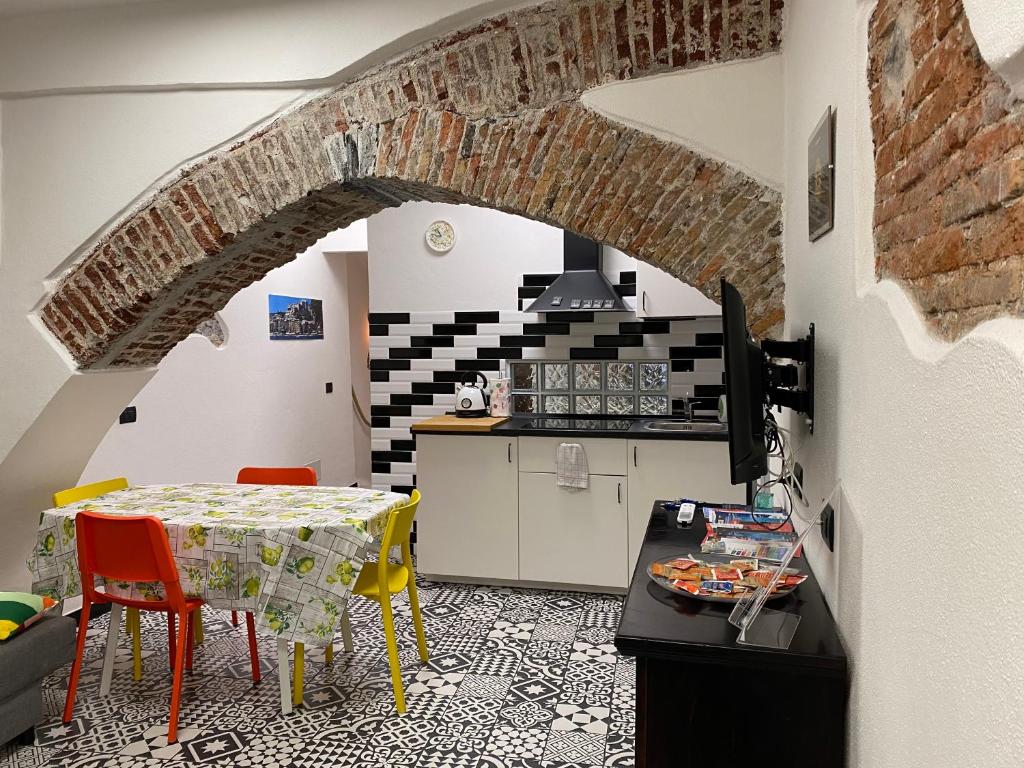 a kitchen with a table and a kitchen with a brick wall at IL MOLO in Genova