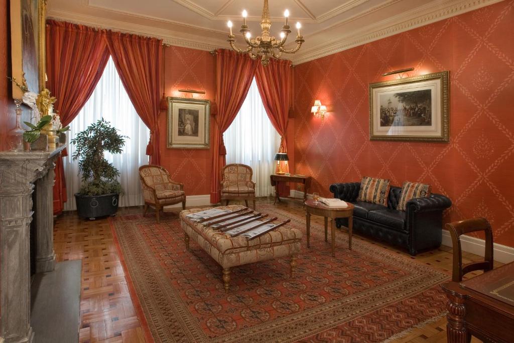 a living room with a couch and a table at Grand Hotel Sitea in Turin