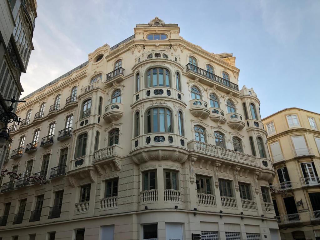a large white building with a balcony at Felix Saenz by Luma in Málaga