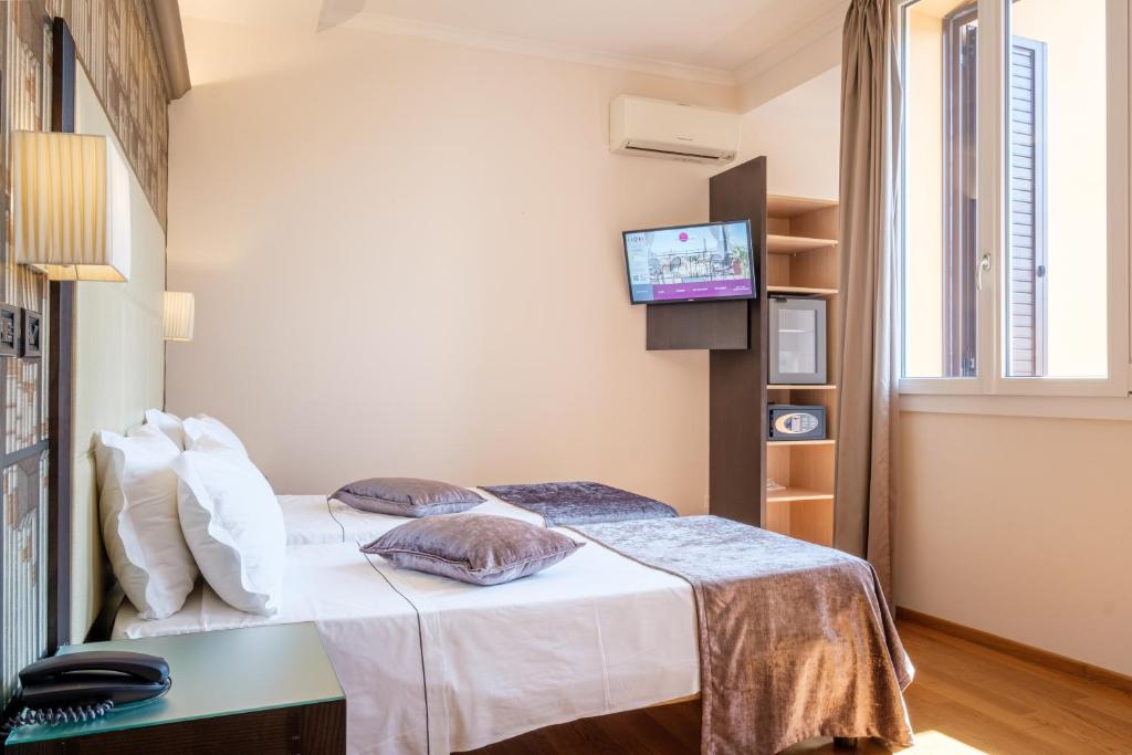 Postel nebo postele na pokoji v ubytování Hotel Touring
