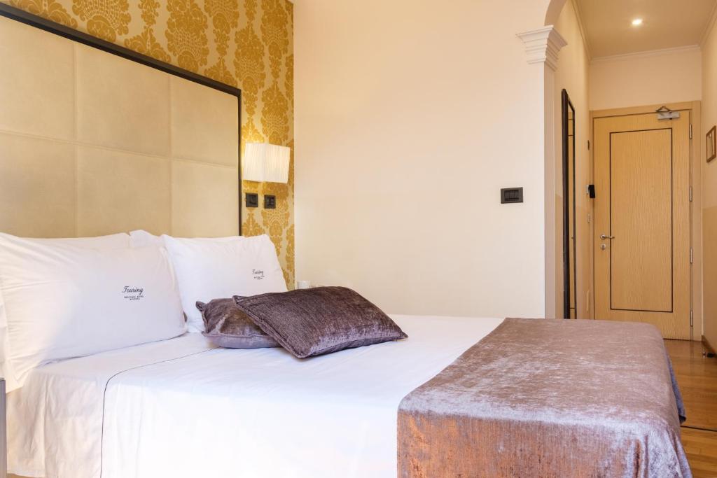Postel nebo postele na pokoji v ubytování Hotel Touring