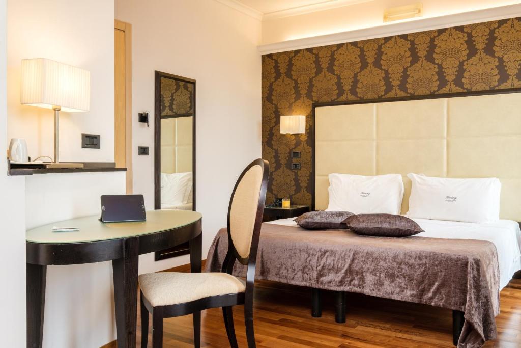 Postel nebo postele na pokoji v ubytování Hotel Touring