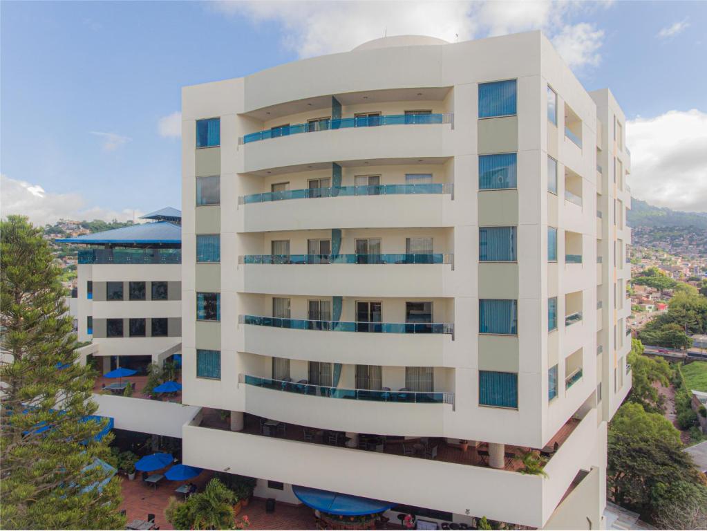 an overhead view of a white apartment building at Hotel Plaza Juan Carlos in Tegucigalpa