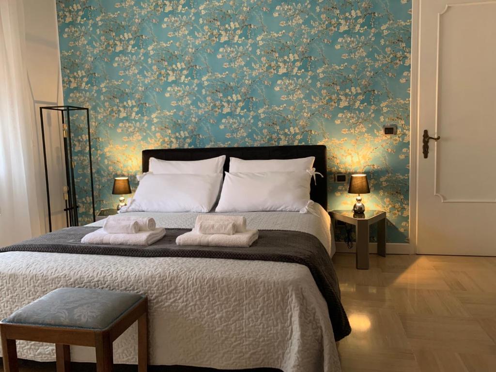 a bedroom with a large bed with a floral wallpaper at Holidays Apartment Toti to fulfill your wishes in Mestre