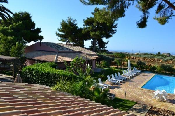 a group of chairs and a swimming pool at Holiday Menfi | Casale Abate in Menfi