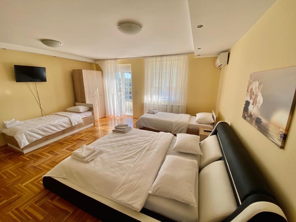 a room with two beds and a living room at Villa Boho Cherga in Belgrade