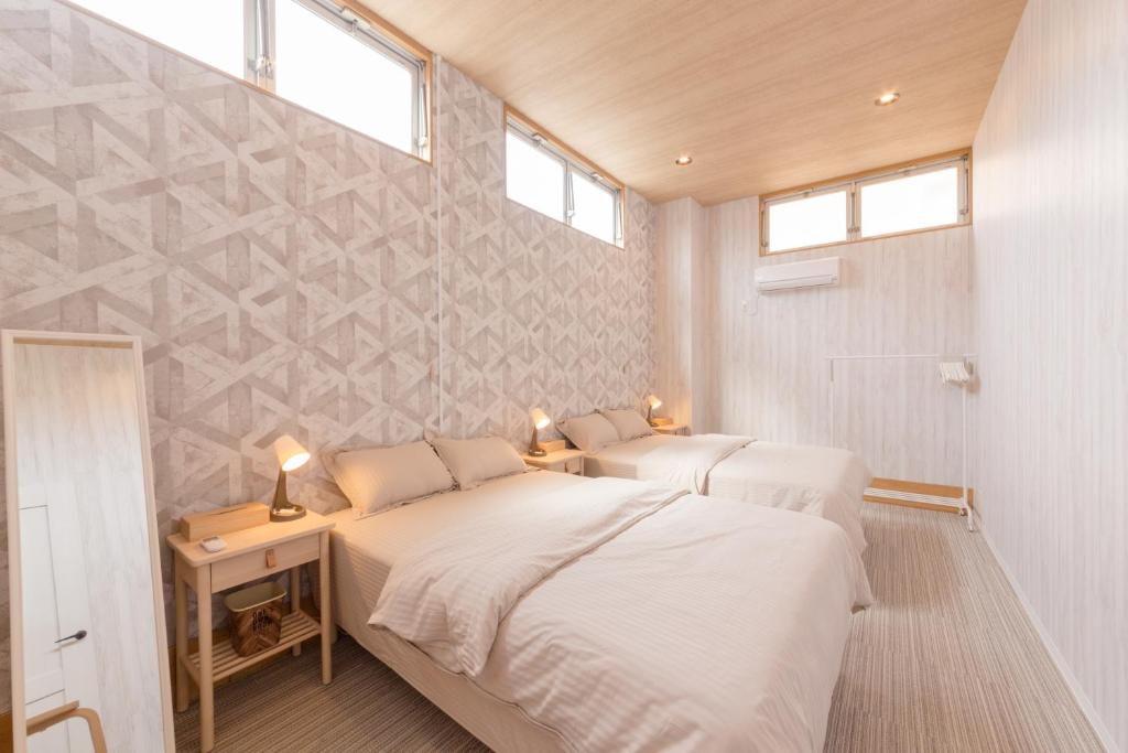 Ένα ή περισσότερα κρεβάτια σε δωμάτιο στο Morihiro-biuilding 守弘ビル #MIYx