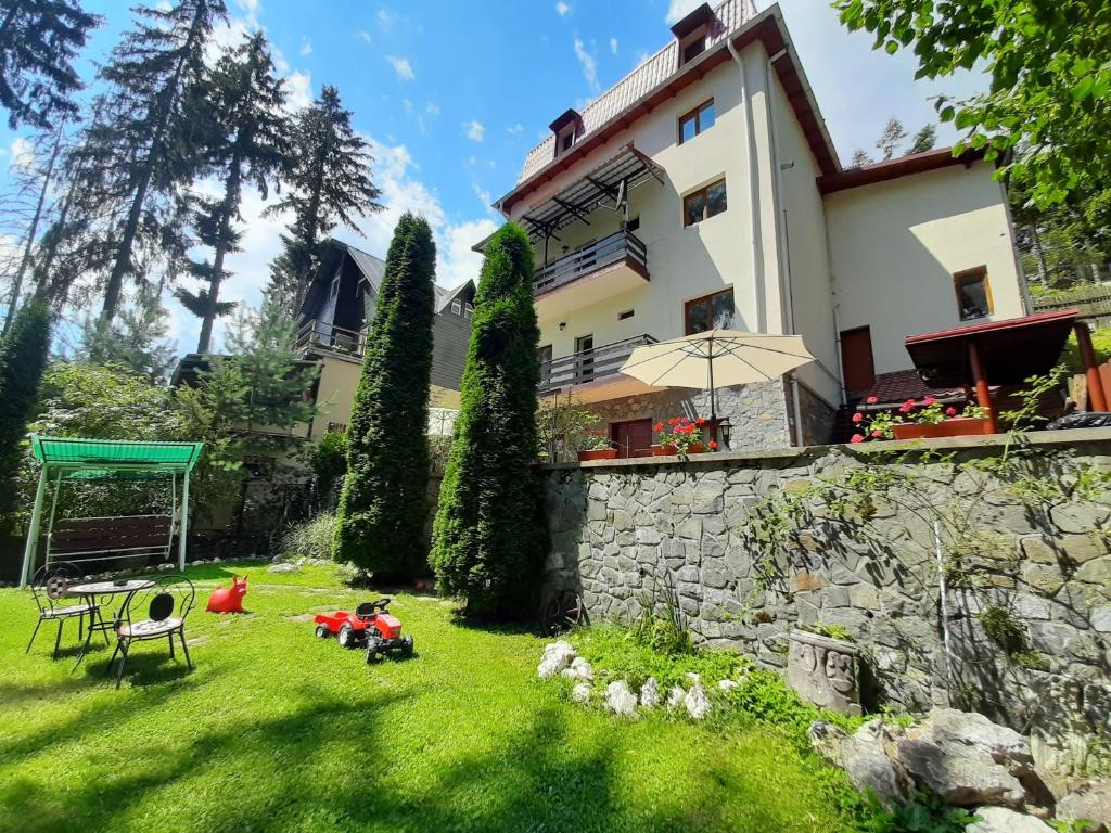a house with a yard with a building at Vila Felix in Sinaia