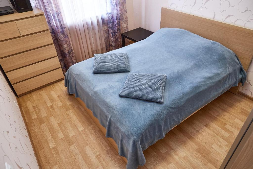 um quarto com uma cama com duas almofadas em J&N APARTMENTS Ленинградский em Vyborg