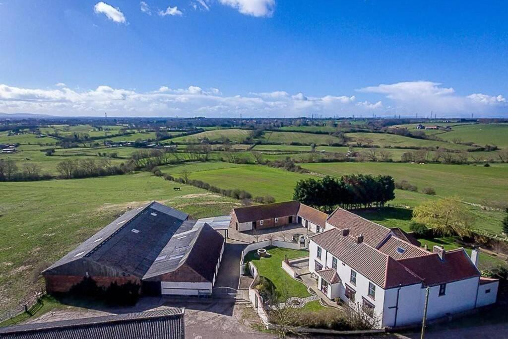 an aerial view of a house in a field at Charming apartment with hot tub , Viewly Hill Farm in Norton