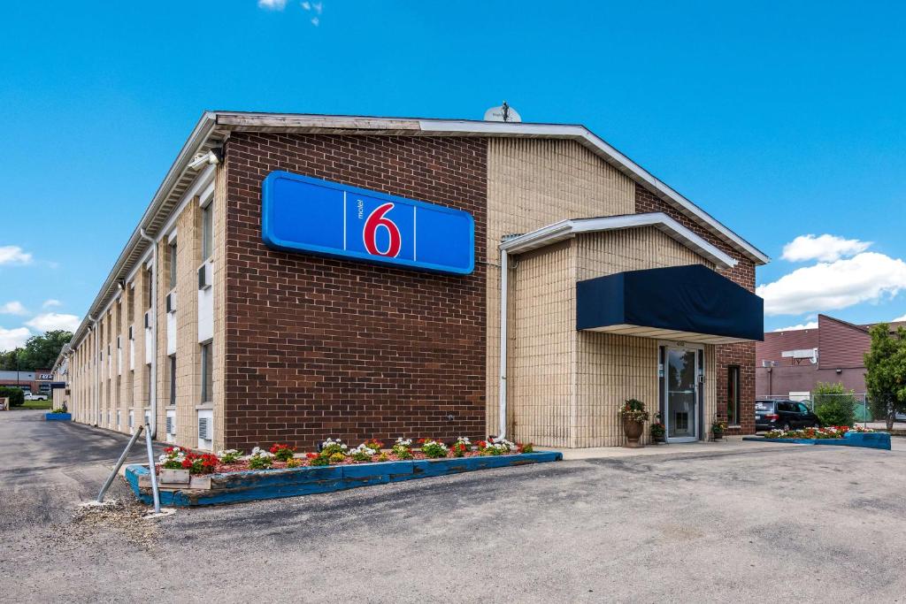 a building with a sign on the side of it at Motel 6-Madison, WI - East in Madison