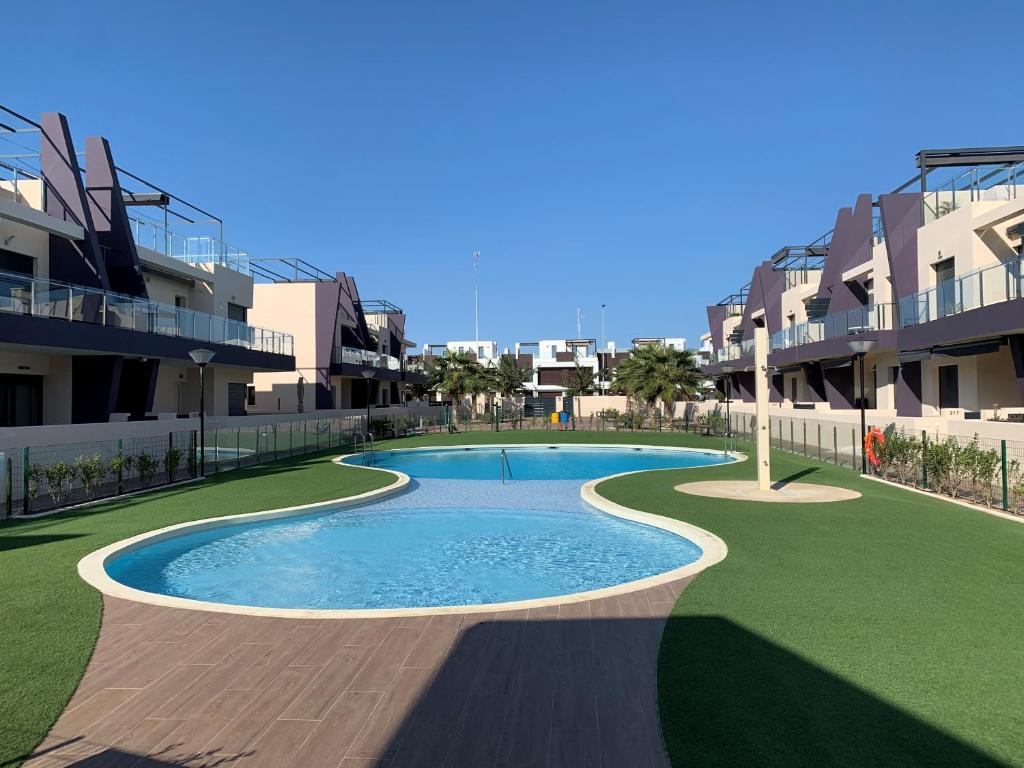 una piscina di fronte ad alcuni edifici di appartamenti di Casa Higuericas- Penthouse Beach - Torre de la Horadada a El Mojón