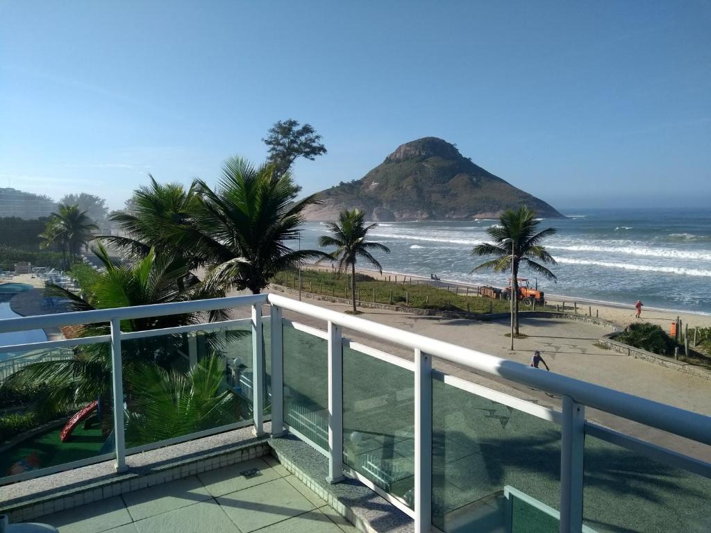 a balcony with a view of the beach at Reserva Pontal in Rio de Janeiro