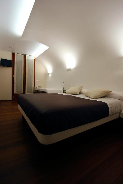 a bedroom with a large bed in a room at Pensión Iturriza in Donostia-San Sebastián