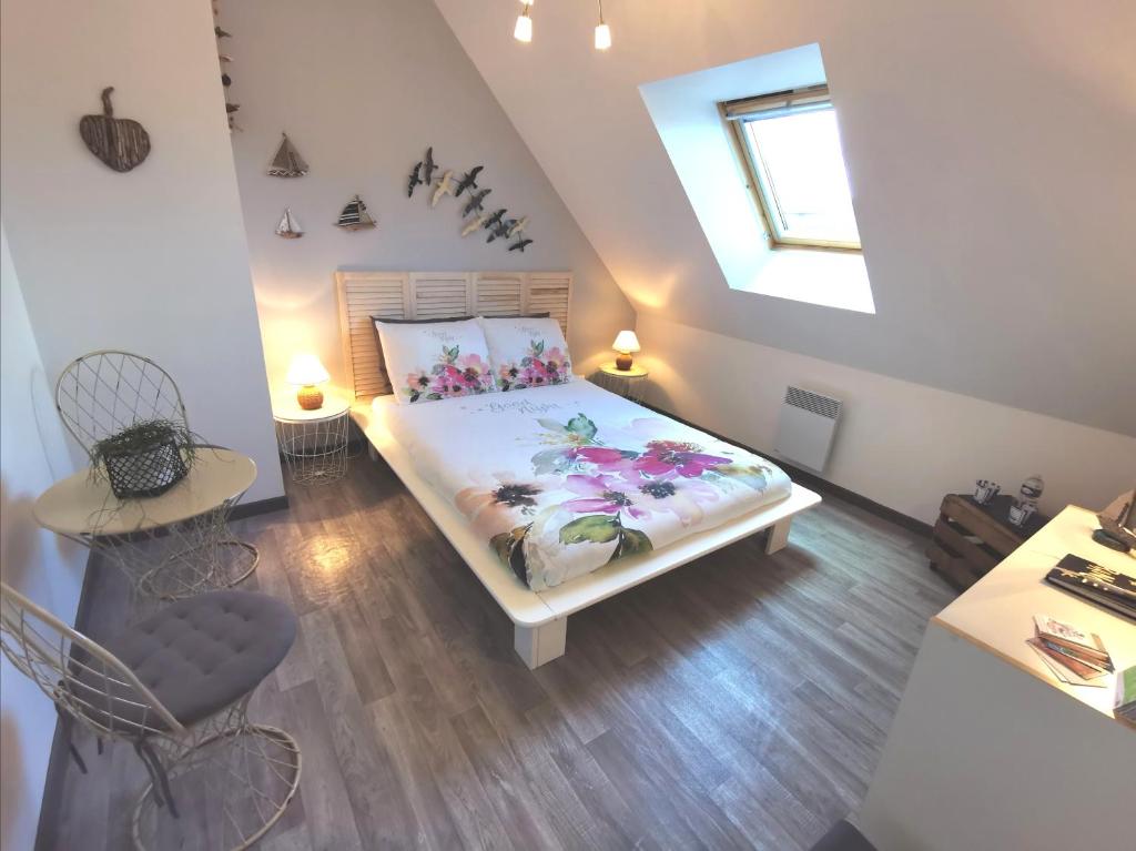 sypialnia z łóżkiem i świetlikiem w obiekcie CHAMBRE D'HOTES Côté RANCE w mieście La Ville-ès-Nonais
