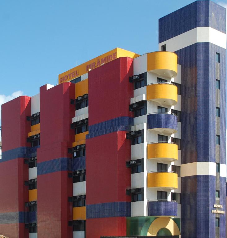a building with colorful balconies on the side of it at Hotel Piramide Pituba - Rua Pernambuco in Salvador