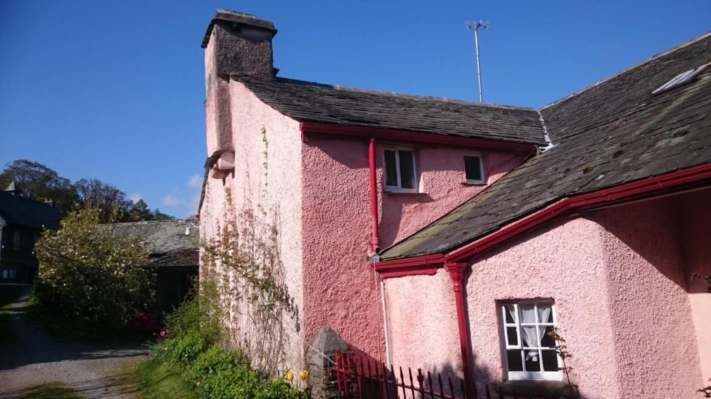 a pink house with a black roof at Low House Farm North, Troutbeck, Windermere in Windermere