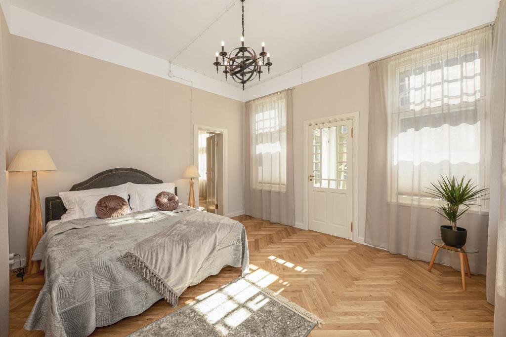 a bedroom with a bed with a teddy bear on it at Tõnisson Apartments in Tartu