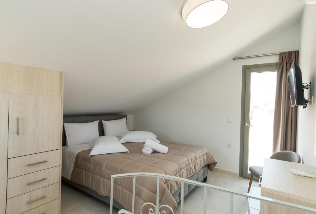 Postel nebo postele na pokoji v ubytování KIPOI APARTMENTS