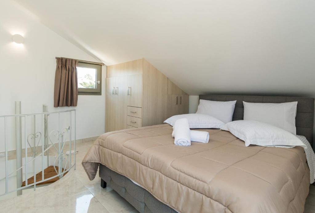 Postel nebo postele na pokoji v ubytování KIPOI APARTMENTS