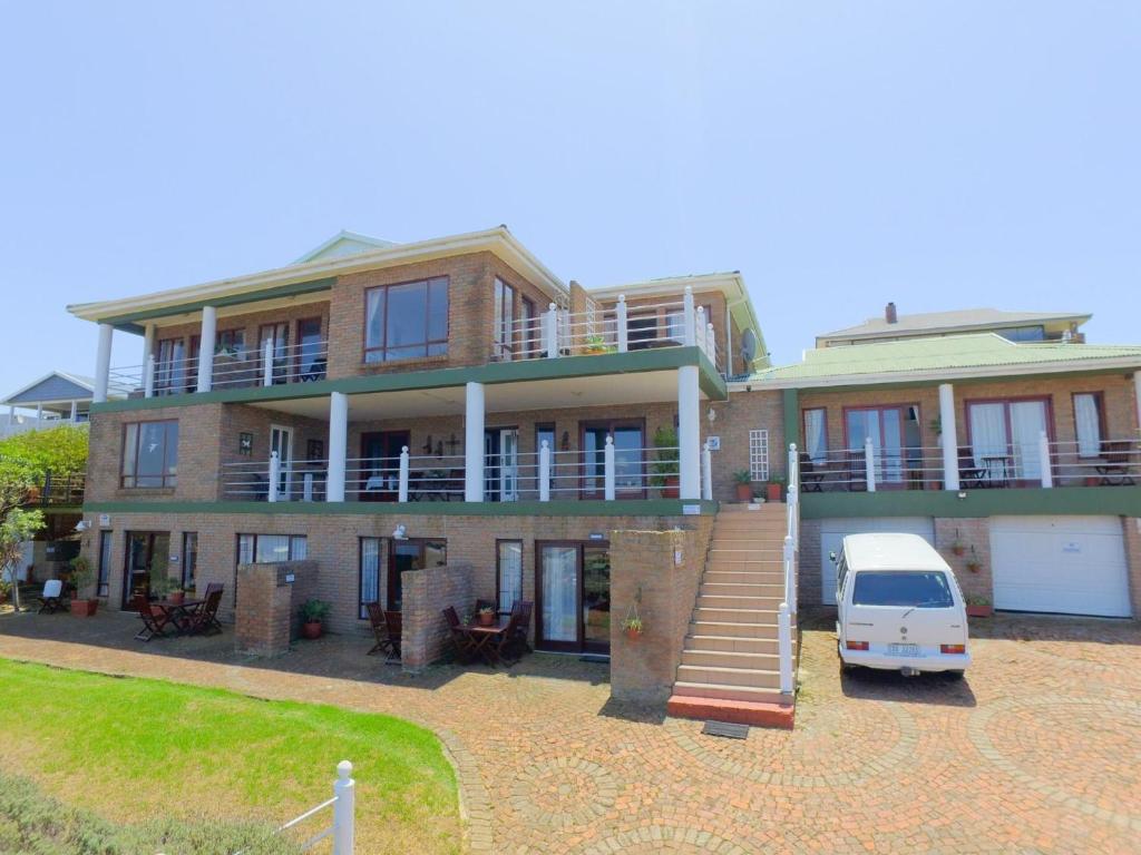 a house with a van parked in front of it at Amzee Bokmakierie Guest House in Dana Bay