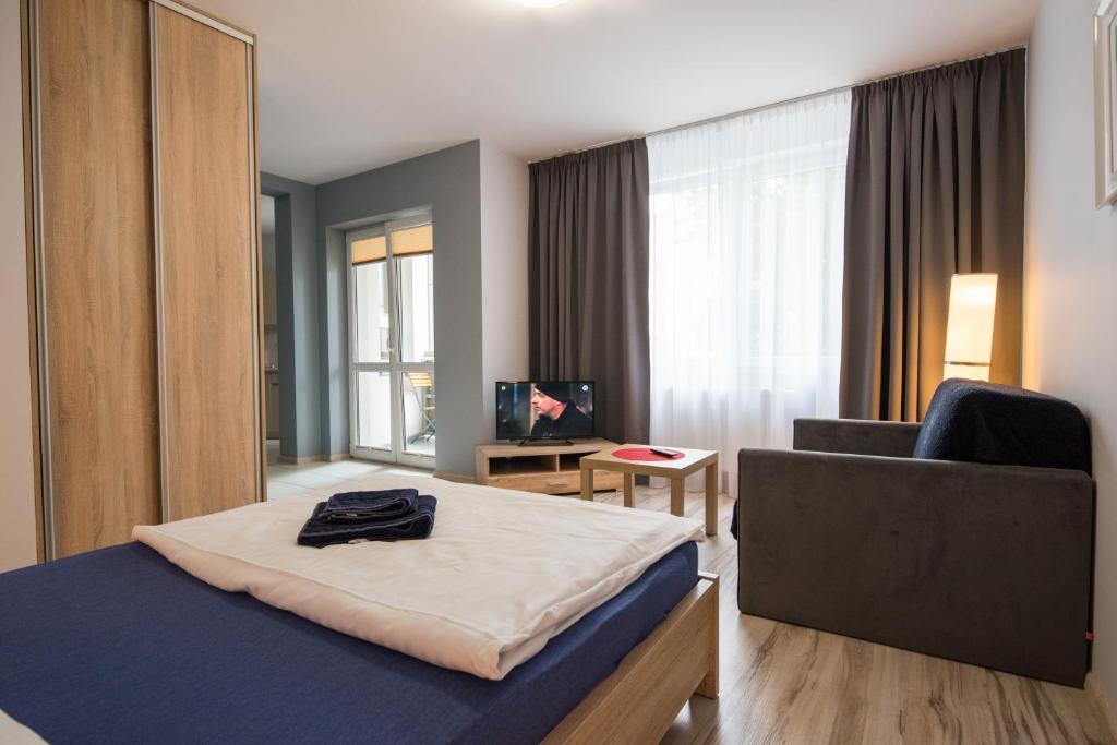 a hotel room with a bed and a chair at Parkowa 13 in Szczecin