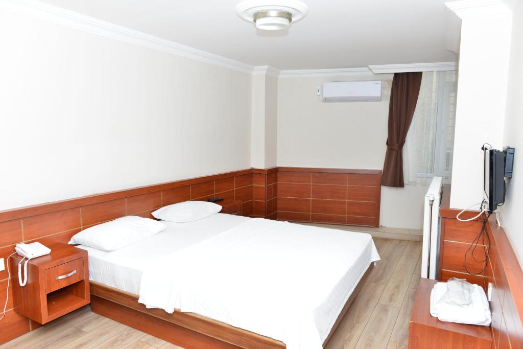 Postel nebo postele na pokoji v ubytování Bilgic Hotel