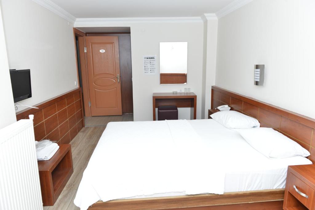 Postel nebo postele na pokoji v ubytování Bilgic Hotel
