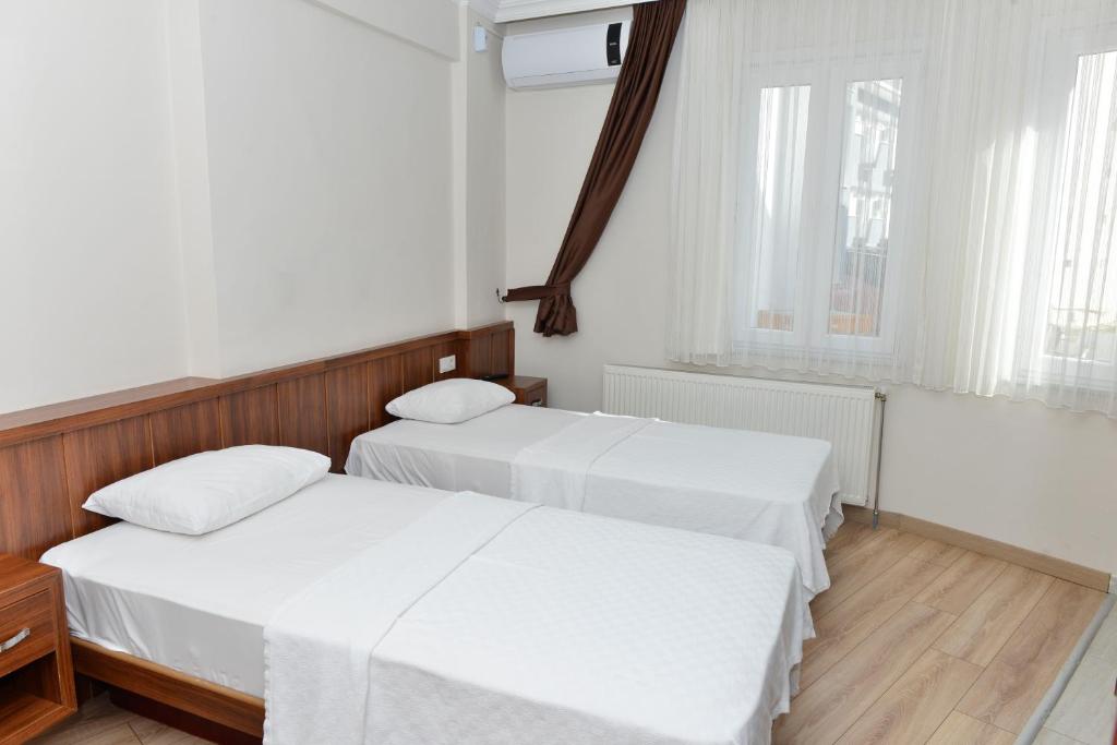 Postel nebo postele na pokoji v ubytování Bilgic Hotel