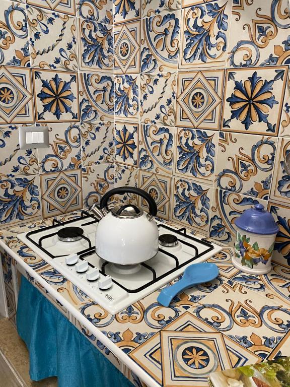 a tea pot on a stove top in a kitchen at Ortigia Dreaming in Siracusa