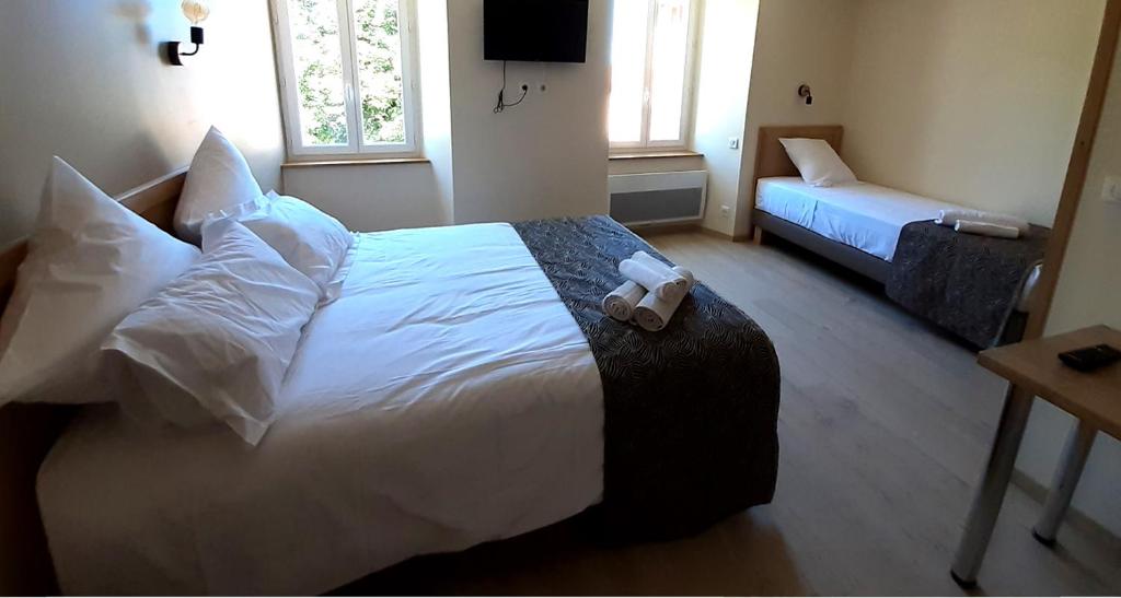 a bedroom with a bed with a teddy bear on it at auberge beausejour in Concoules