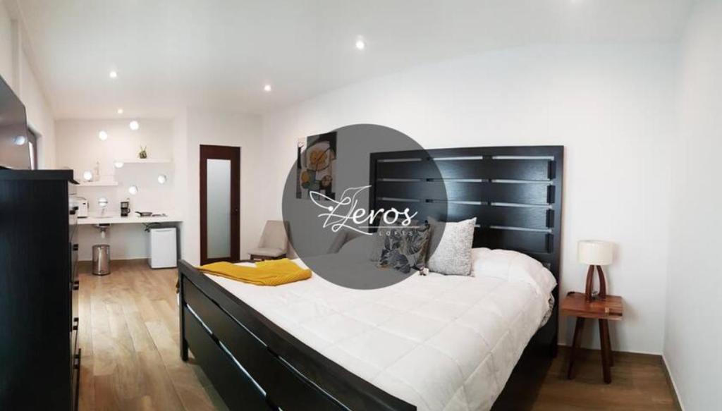 a bedroom with a large bed with a sign on it at HEROS in Lagos de Moreno