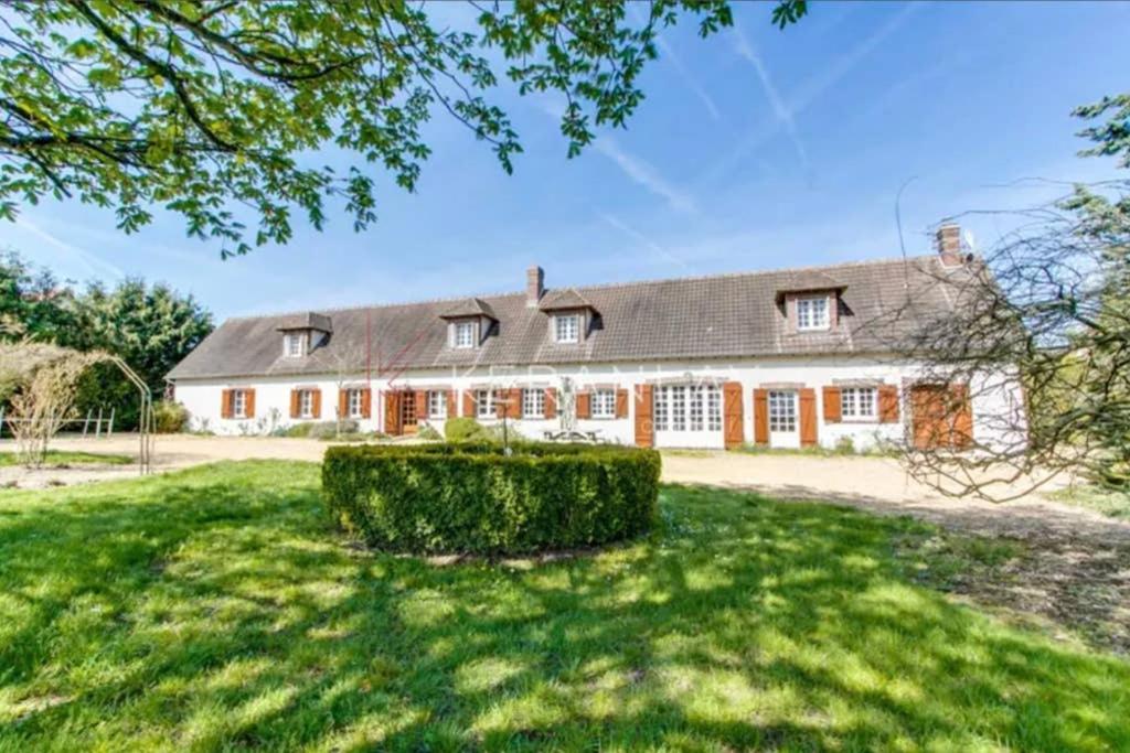an exterior view of a large house with a yard at Kasa Des Bois in Saint-Arnoult-des-Bois