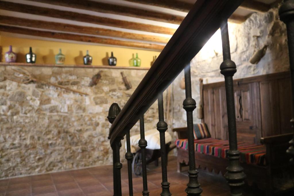 escalera en una habitación con pared de piedra en Casa rural tres regiones en Ontiñena