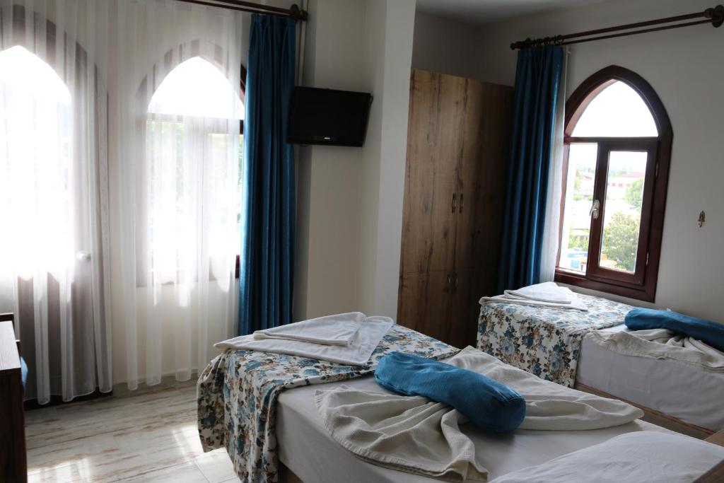 Postel nebo postele na pokoji v ubytování Eroglu City Hotel