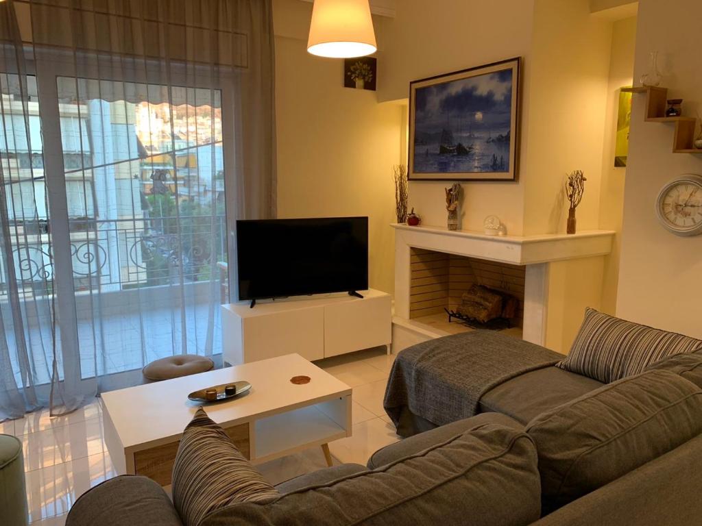 a living room with a couch and a television at New luxury apartment in central suburb of Athens in Athens