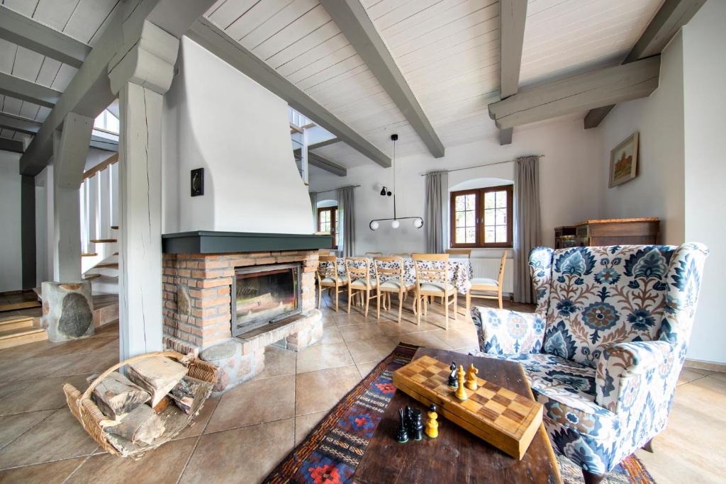 a living room with a fireplace and a table at Blossom Hill Apartments in Łęcze