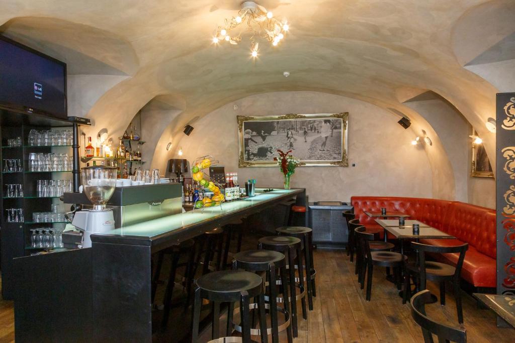 a bar in a restaurant with a bunch of stools at Hotel Aplaus in Litomyšl