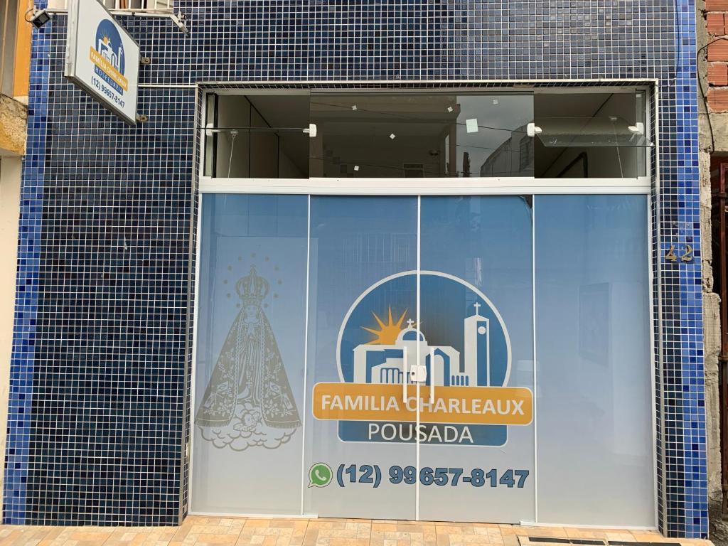 a window of a building with a sign on it at FAMÍLIA CHARLEAUX in Aparecida