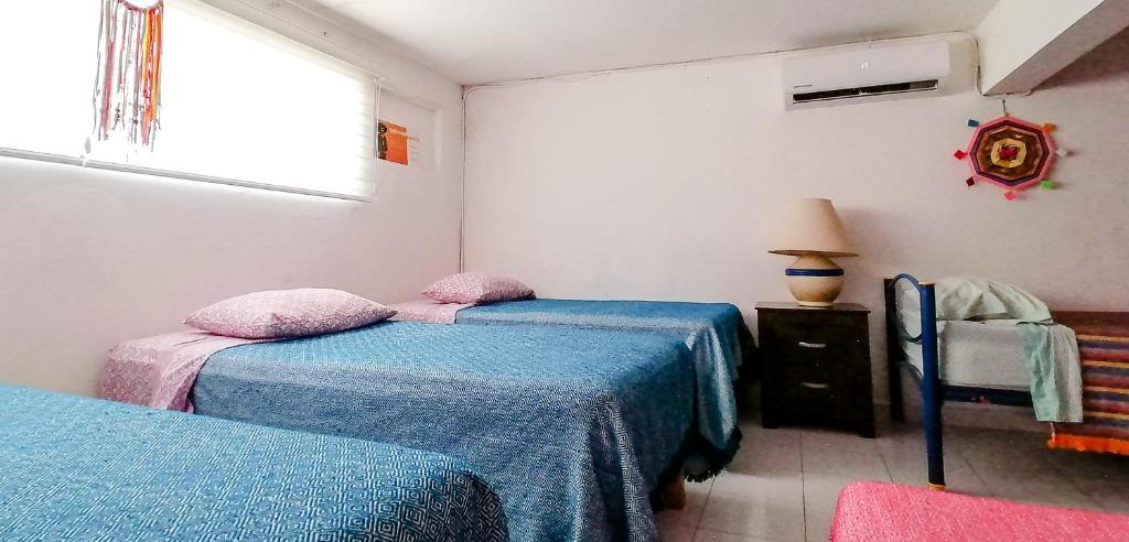 Postel nebo postele na pokoji v ubytování Hostel Vallarta