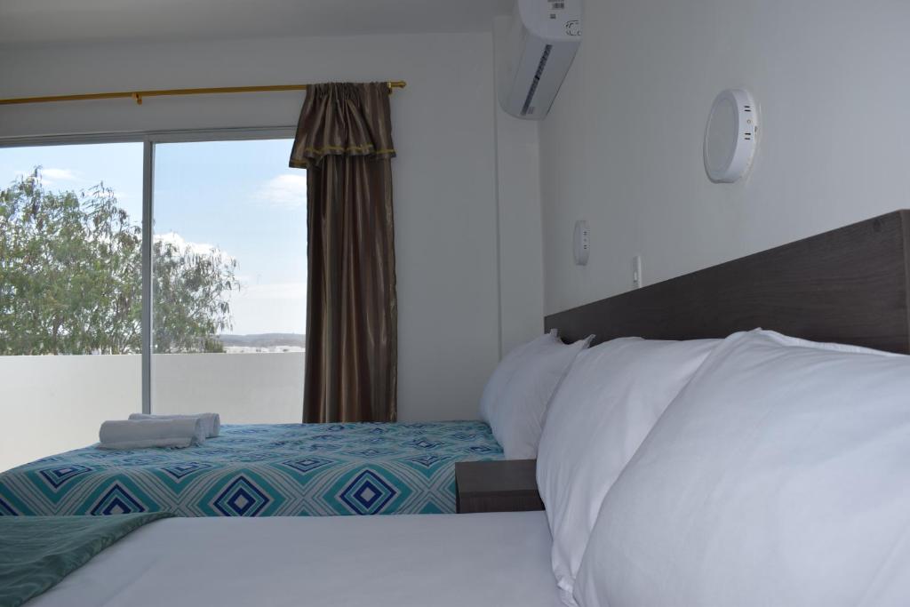Postel nebo postele na pokoji v ubytování Mare S&M Casa Hostal