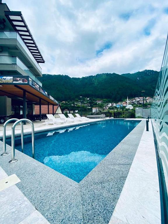 a large swimming pool next to a building at Hotel Novalić Konjic in Konjic