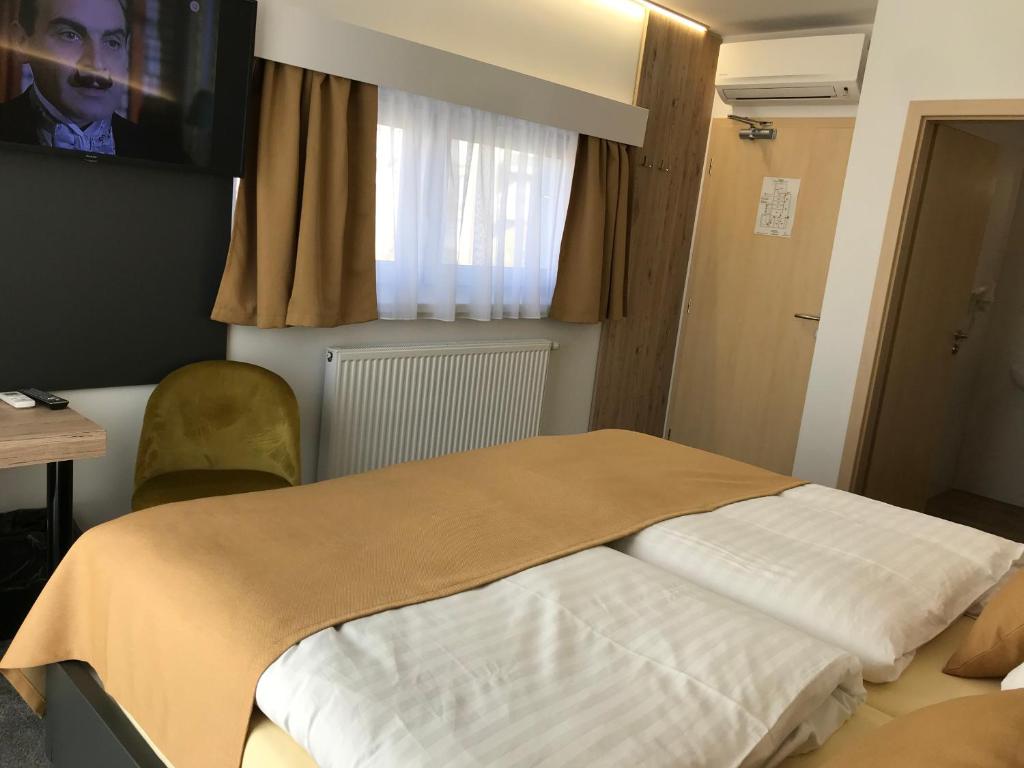 A bed or beds in a room at Primma Hotel