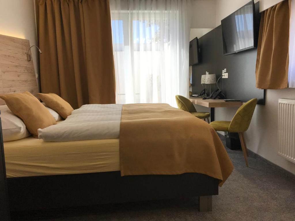 A bed or beds in a room at Primma Hotel