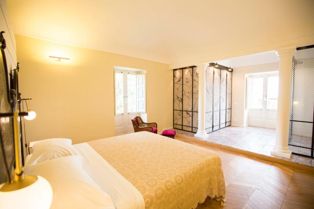 Postel nebo postele na pokoji v ubytování B&B Attico Taranto