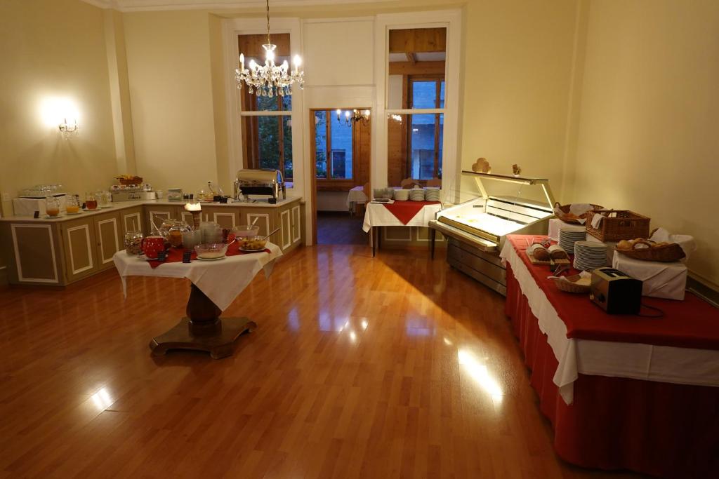 a large room with two beds and a table at Hotel Schweizerhof in Engelberg