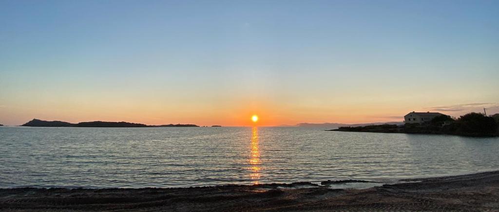 a sunset over a body of water with a beach at Villa Roka in Six-Fours-les-Plages